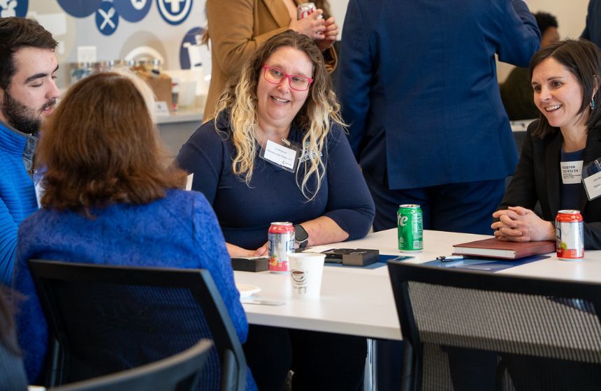 A diverse group of people chatting in a circle.
