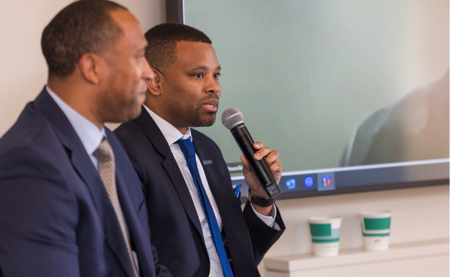 Two men speaking at a Pacesetters event.
