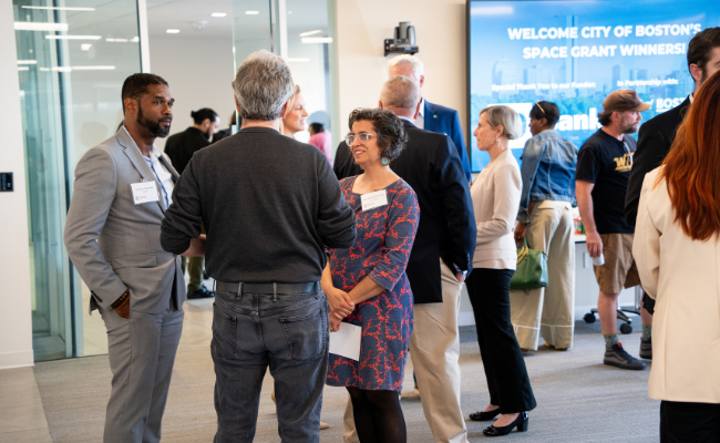 A crowded room of professionals networking.