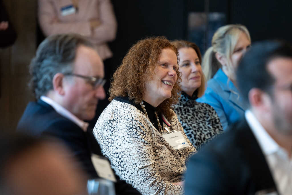 A audience member smiling during the Greater Boston Chamber of Commerce's Executive Exchange event.